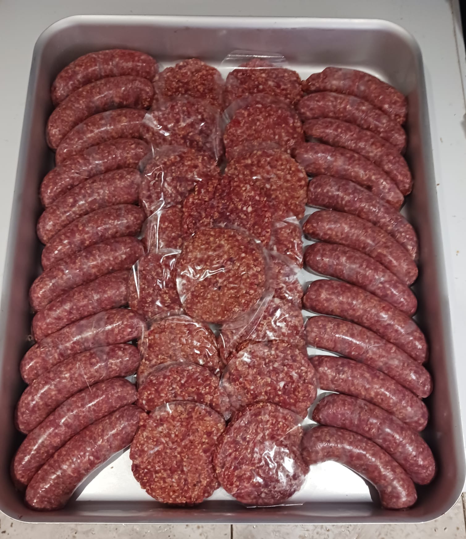Raw wild venison burgers and sausages